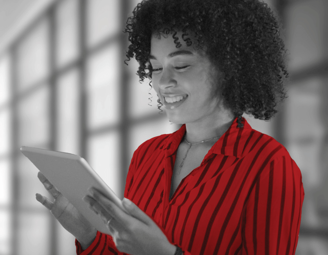 Woman using iPad and smiling