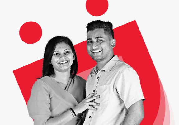 Two people smiling with Digicel logo in the background
