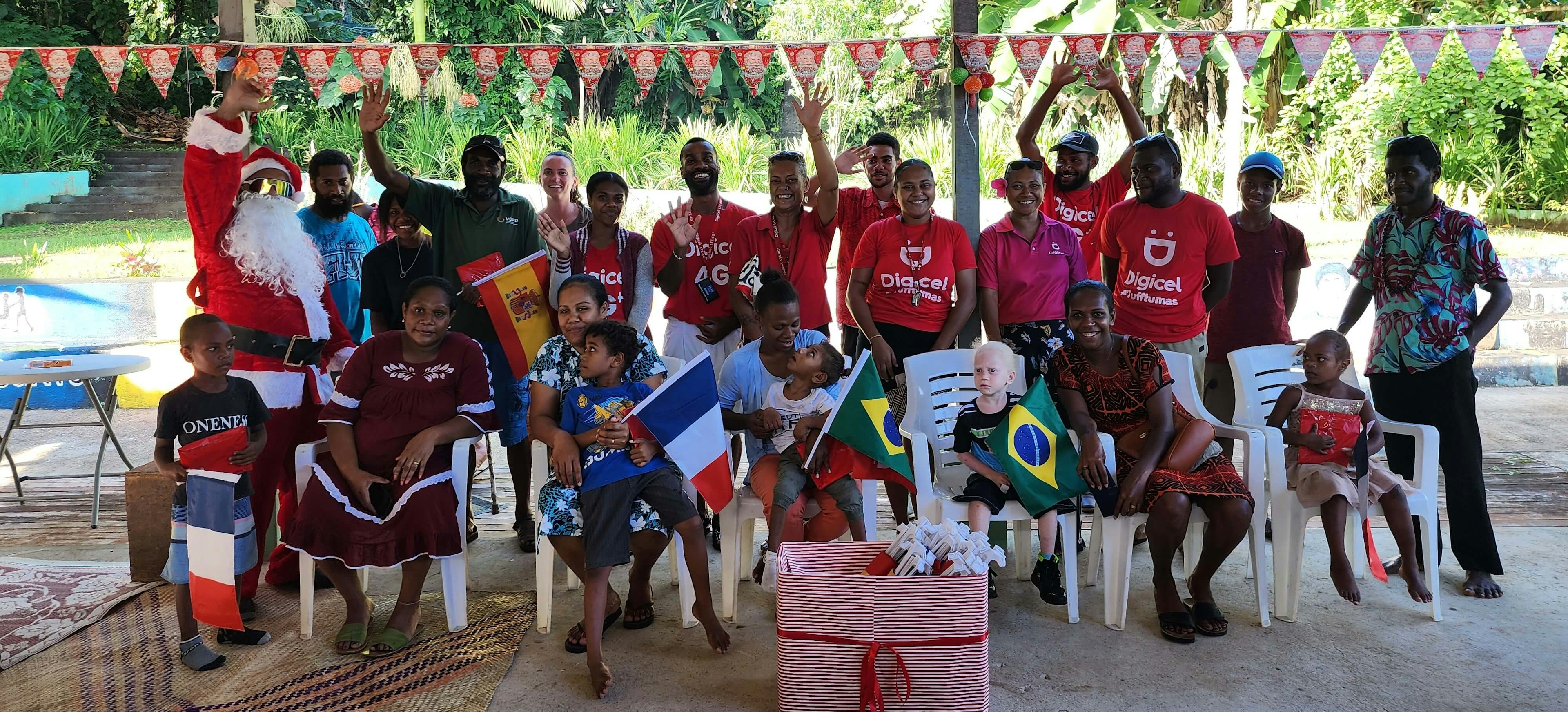 A group of Digicel staff with children from the Early Intervention program at the Vanuatu Society for People with Disability and their parents